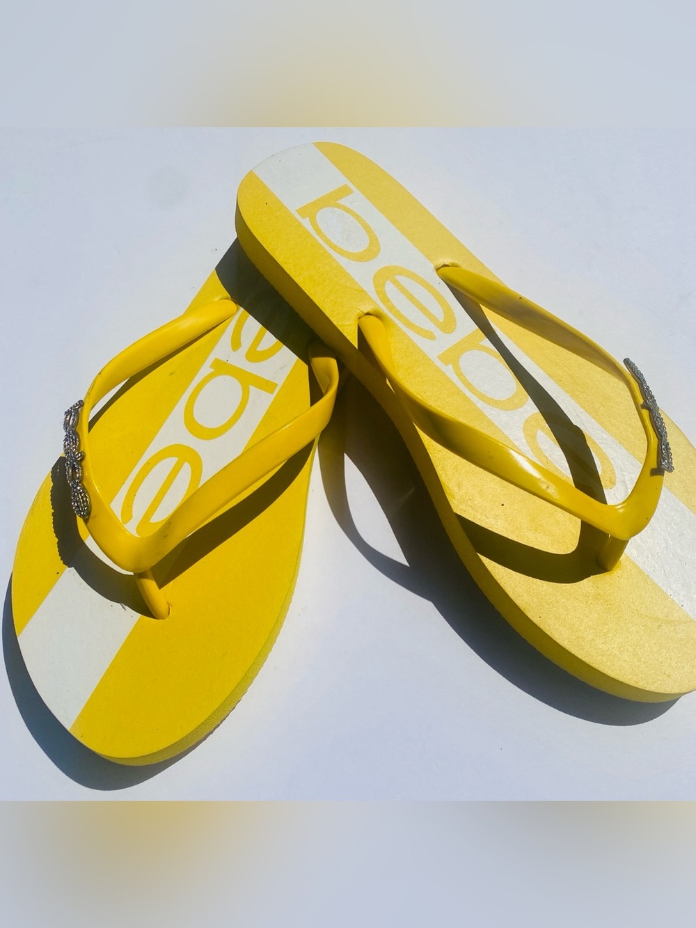 bebe Yellow and White Logo Stripe Flip Flops with Rhinestone Detail